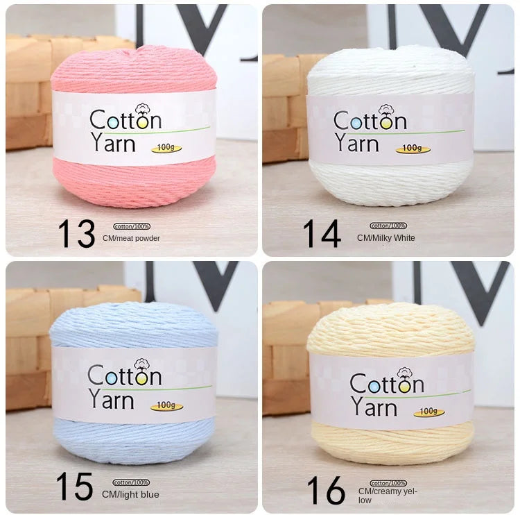 Six rolls of 100% cotton yarn in various colors including pink, white, light blue, and creamy yellow.