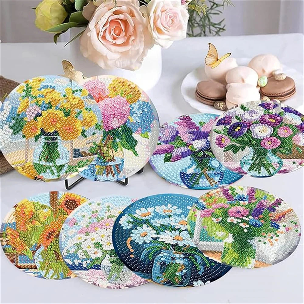 Eight diamond painting coasters featuring floral designs in various colors and patterns with metal holders