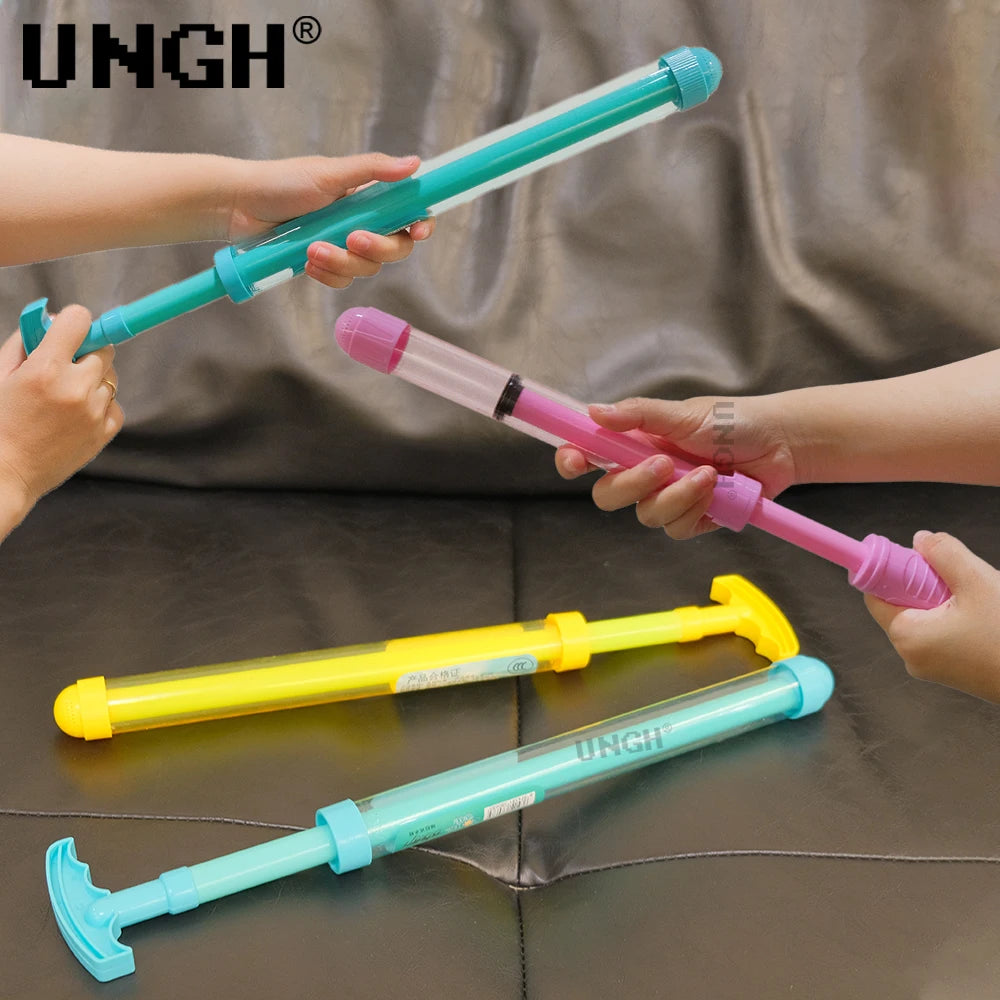 Hands are holding various colored pull-out water guns, including blue, pink, and yellow models.