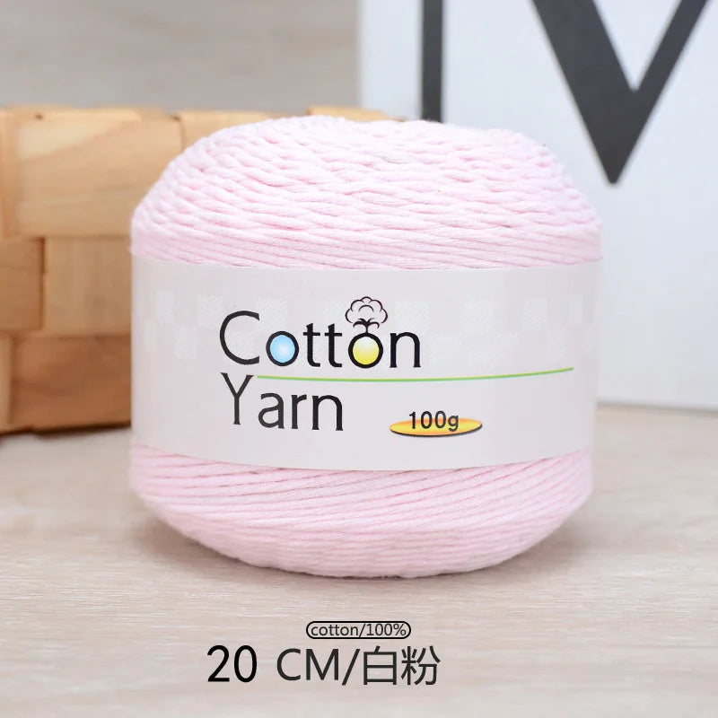 Pink cotton yarn skein labeled 100g and 20 cm long for knitting or crochet