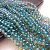 A close-up of a strand of iridescent blue and green crystal beads with an AB coating.