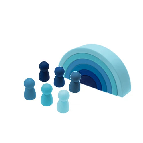 A set of soft silicone rainbow building blocks in shades of blue and purple, arranged in a curved arc.