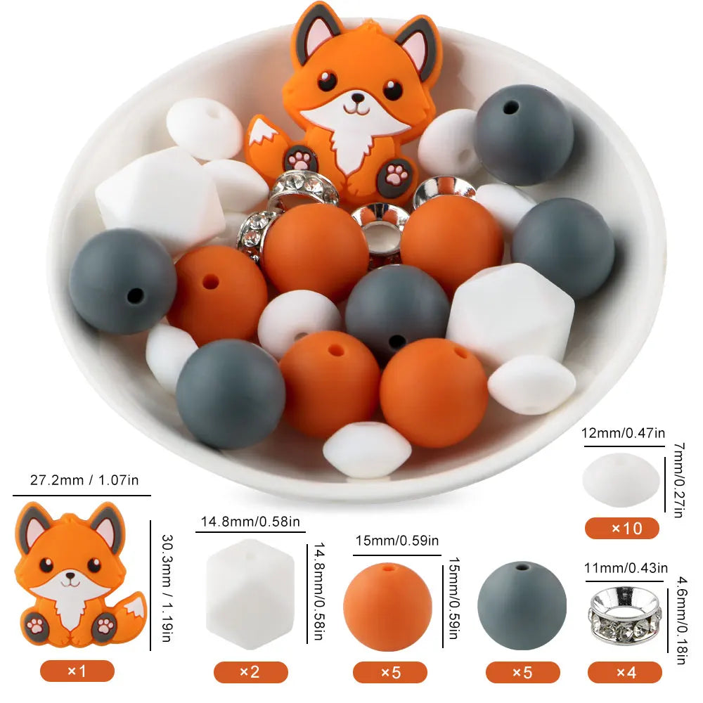 A bowl filled with various orange and gray silicone beads shaped like foxes, including round, flat, and ring-shaped pieces.