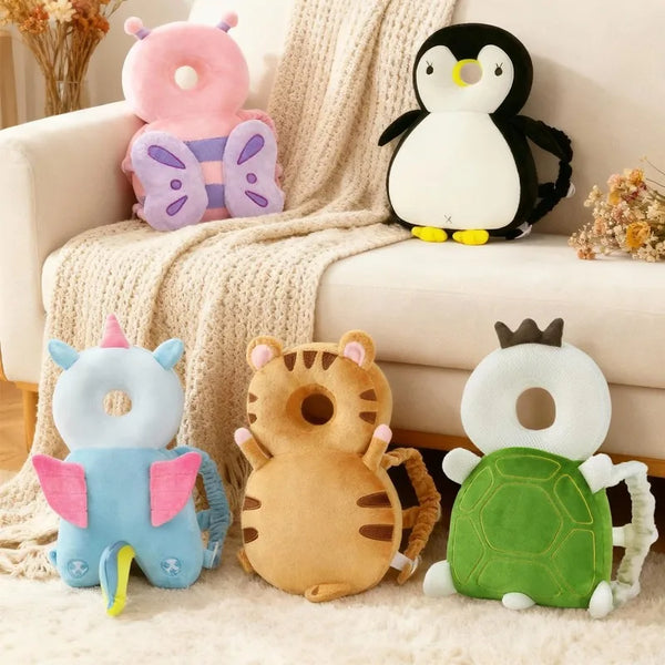 A collection of plush animal toys including a pink elephant, a black penguin, a blue dinosaur, a tiger, and a green turtle.