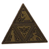 A set of enamel pins featuring geometric and stylized cartoon designs on a brown fabric background.