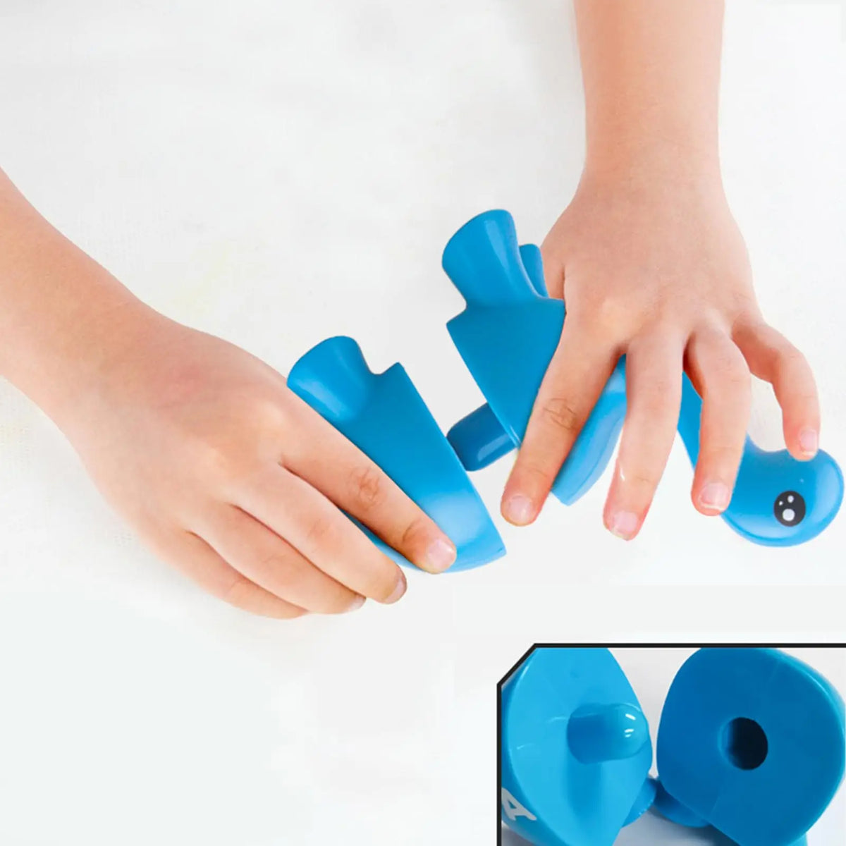 A child's hands are holding a blue alphabet matching set for literacy learning.