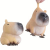 A light tan squishy capybara stress relief toy with black facial markings.