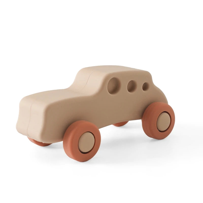 A beige silicone baby teether toy shaped like a cartoon car with round wheels.
