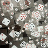 A collection of waterproof transparent playing cards featuring various suits and cards scattered on a dark surface.