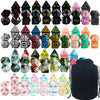 A collection of polyhedral dice in various colors and shapes displayed next to a black drawstring bag.