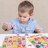 A young child is interacting with a colorful wooden alphabet and number puzzle for learning.