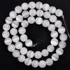 A circular arrangement of smooth, translucent white and light blue natural sea sediment jasper and turquoise beads for jewelr