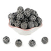 A pile of black and silver rhinestone acrylic beads for jewelry making