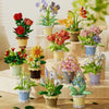 A collection of miniature flowers in various colors and arrangements displayed on wooden blocks.