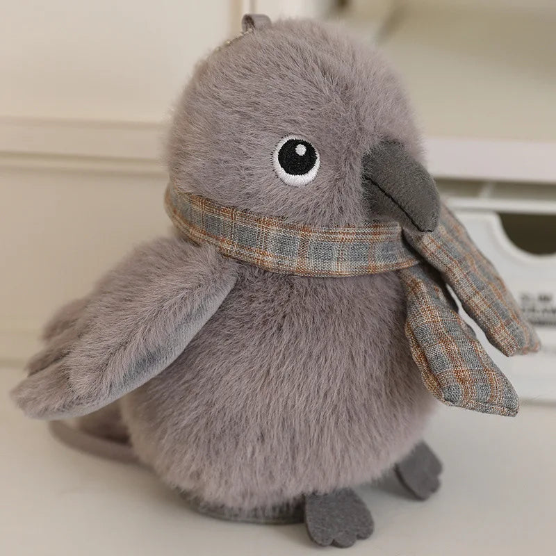 A soft gray cartoon bird plush with large eyes and a beak, designed as a keychain or pendant.