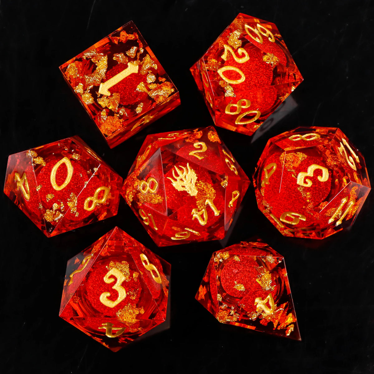A collection of red resin dice with gold glitter accents arranged on a black surface.