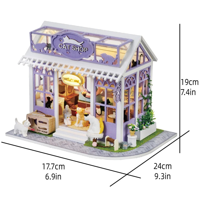 A miniature cat shop dollhouse kit featuring a purple and white building with detailed furniture and warm lighting.