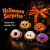 A collection of spooky Halloween squishy fidget toys including a pumpkin, ghost, and purple slime, displayed on a dark surfac