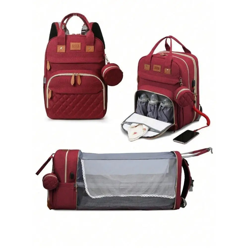 A maroon backpack diaper bag featuring a padded changing pad and an external USB port.