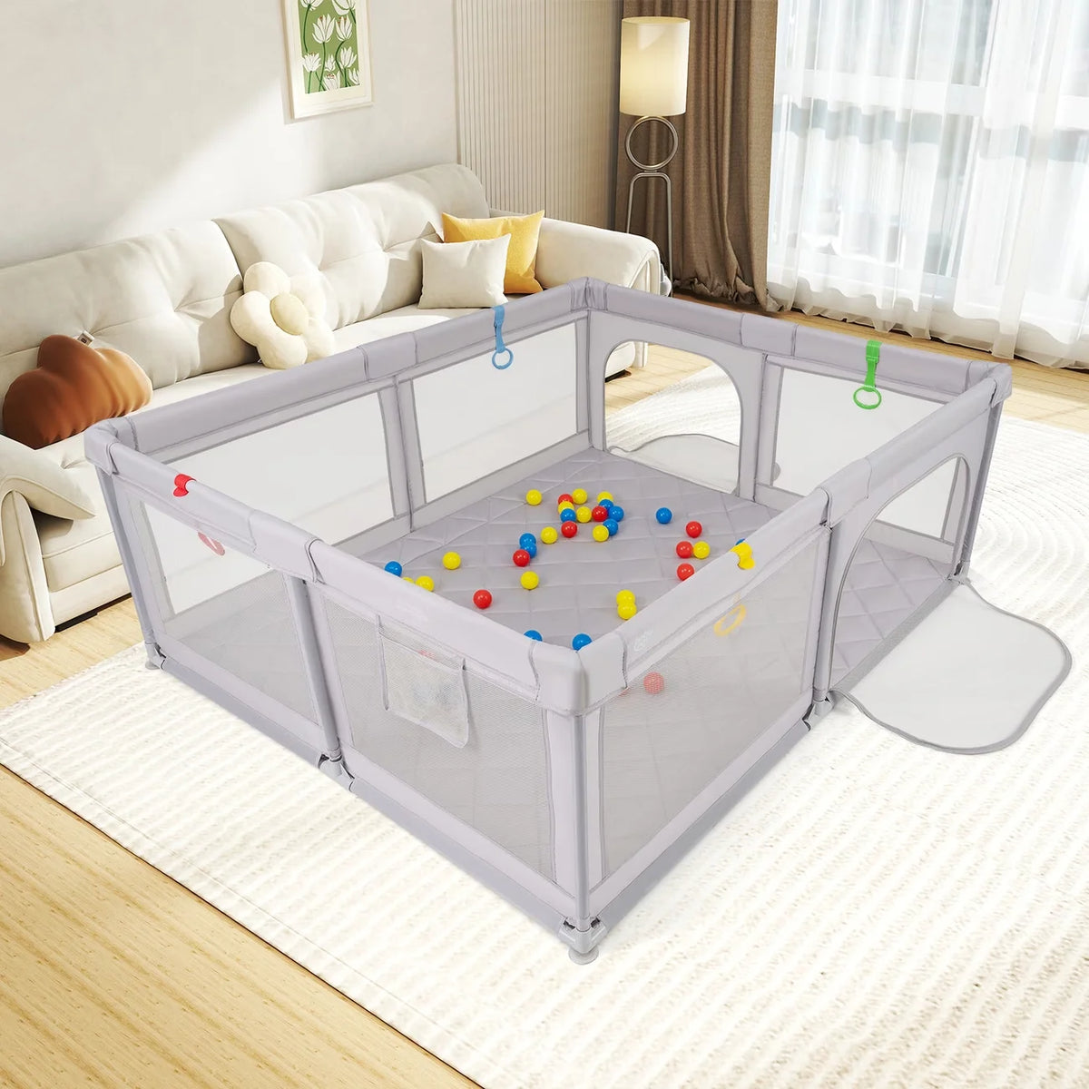 A large gray baby playpen with breathable mesh is set up indoors on a rug for children's activity.