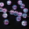 A string of gradient crystal glass beads with a golden crackle finish, showing various shades of purple and blue.