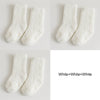 Three pairs of white fluffy anti-slip fleece socks displayed against a light background.