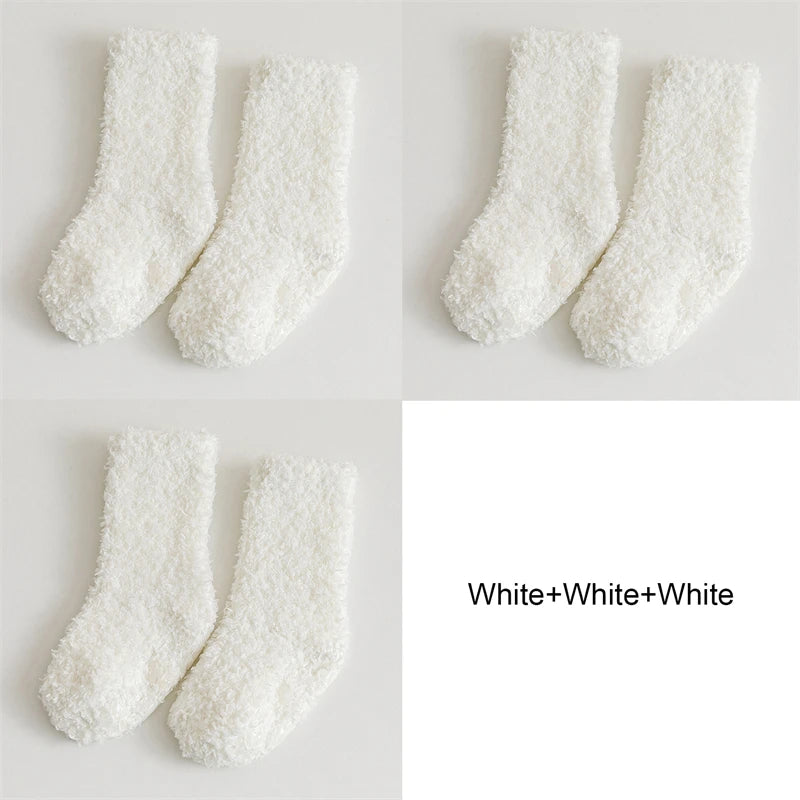Three pairs of white fluffy anti-slip fleece socks displayed against a light background.