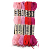 A set of six vibrant embroidery threads in various shades of pink, purple, and red for cross stitch and DIY crafts