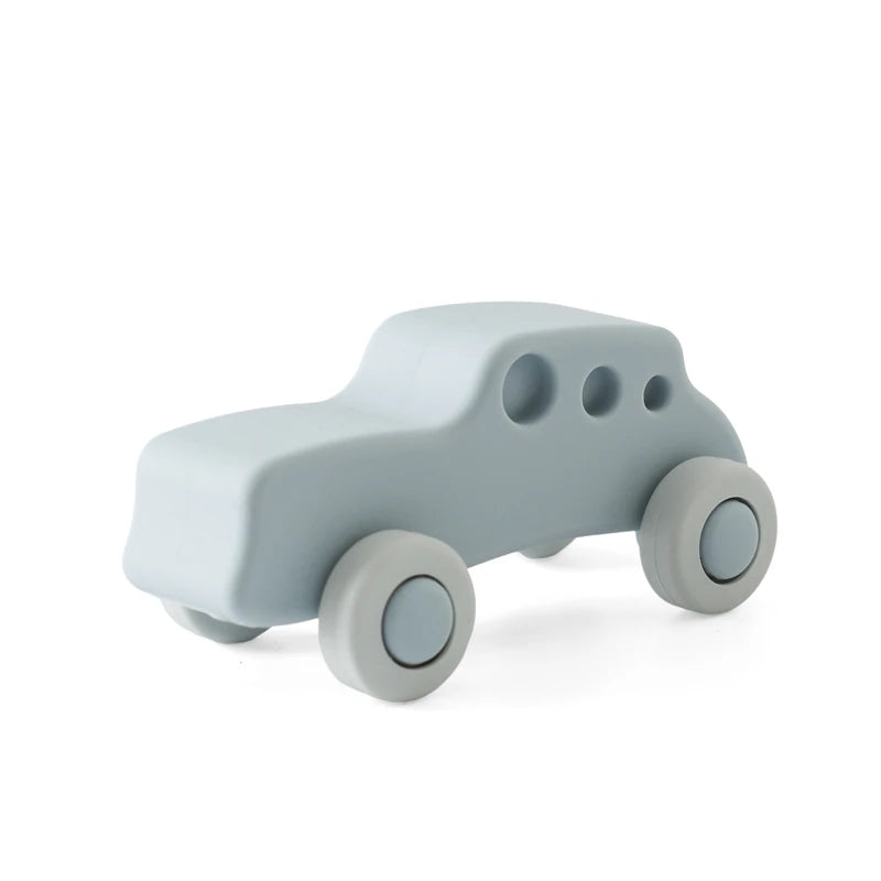 A light gray wooden and silicone car teether toy for babies.