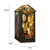 A dark blue miniature bookshelf book nook kit featuring a detailed diorama with illuminated elements and a tree canopy.