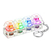 A set of four clear plastic keyboard fidget toys with colorful LED lights attached to a silver keychain.