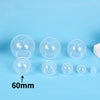 A collection of clear silicone sphere molds for resin crafting, showing various sizes and shapes.