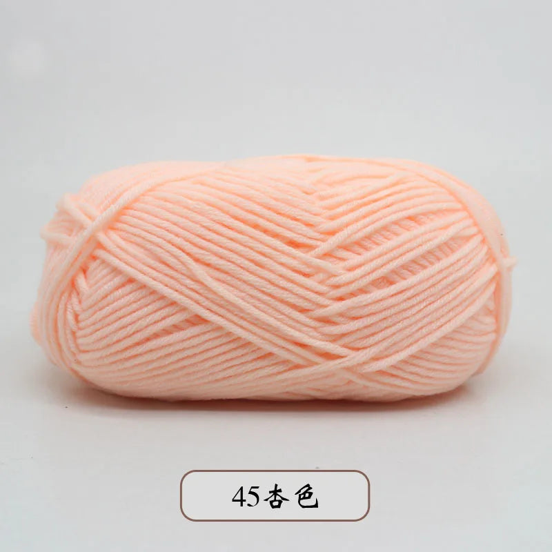 A ball of light peach colored pre-dyed milk cotton yarn for knitting and crochet.