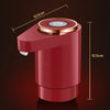 A red electric water dispenser pump with a circular top and dual outlets is shown against a dark background.