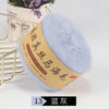 A ball of light blue mohair blended yarn for knitting shawls and sweaters is displayed next to a gold wire rack.