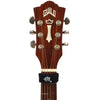 A close-up view of a wooden guitar neck featuring a gold inlay and tuning pegs.
