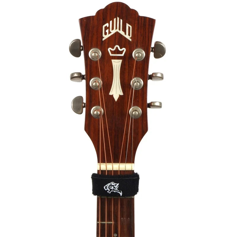 A close-up view of a wooden guitar neck featuring a gold inlay and tuning pegs.