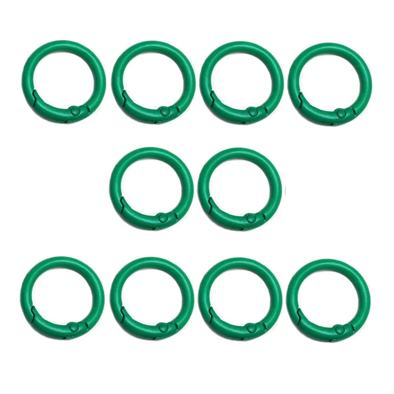 A set of ten green alloy snap hook keychain clips arranged in a row.