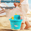 A child holds a clear mesh storage net bag containing an orange and blue plastic cup toy for beach play.