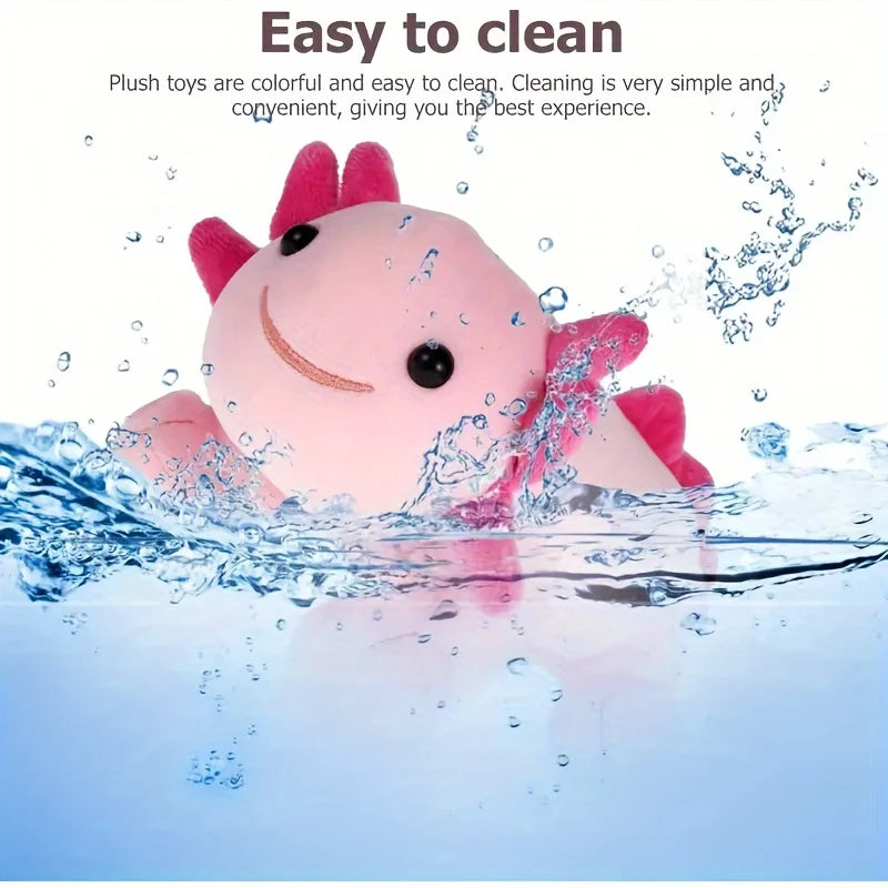 A pink axolotl plush toy is being washed in clear water, emphasizing its easy to clean feature.