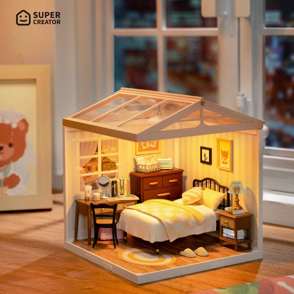 A miniature dollhouse kit featuring a sweet dream bedroom with LED lighting, displayed on a wooden floor.