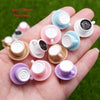 A hand holds multiple colorful ceramic coffee cups used as DIY sunflower charms for jewelry making.