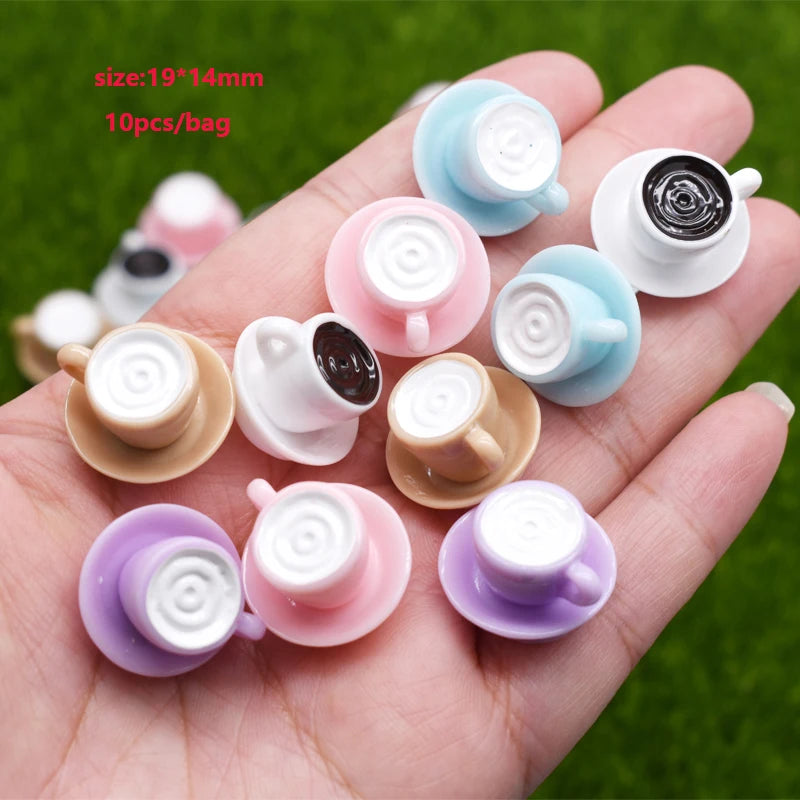 A hand holds multiple colorful ceramic coffee cups used as DIY sunflower charms for jewelry making.