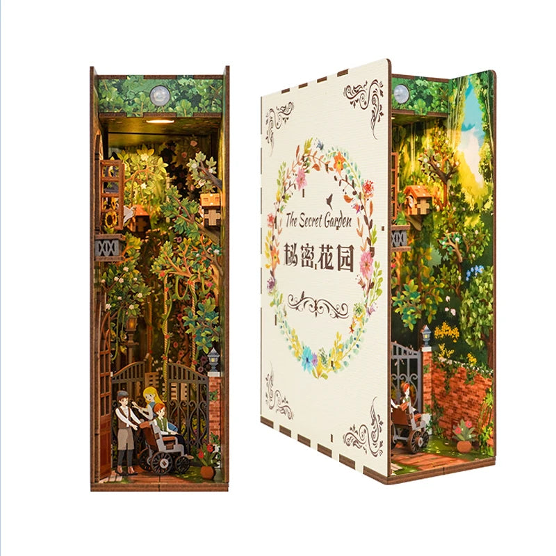 A DIY book nook kit featuring a detailed miniature garden scene with LED lighting and a dust cover.