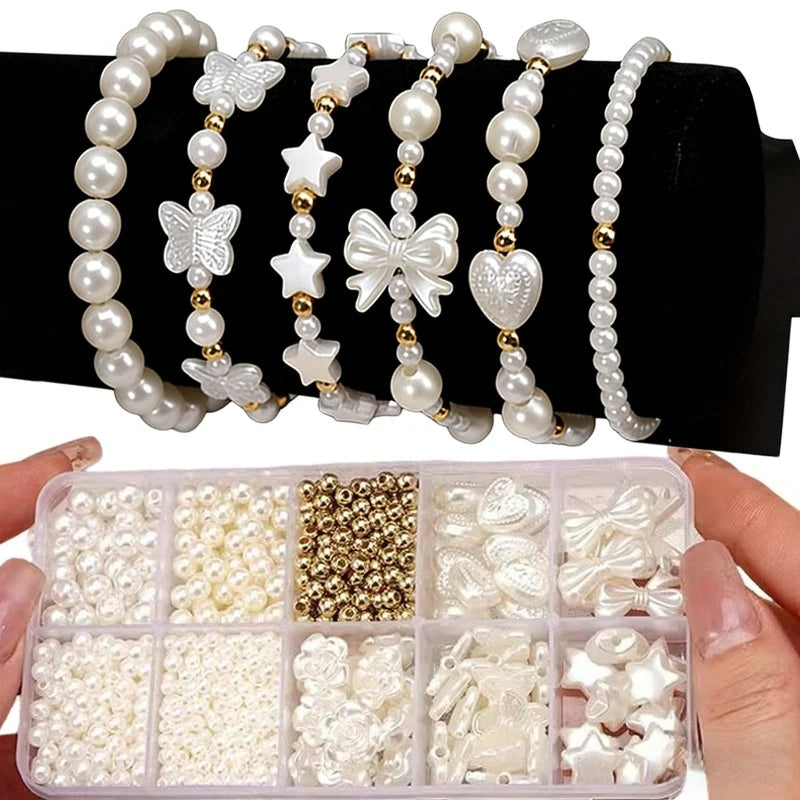 A collection of pearl beading beads, including various sizes and accessories, is displayed in small compartments.