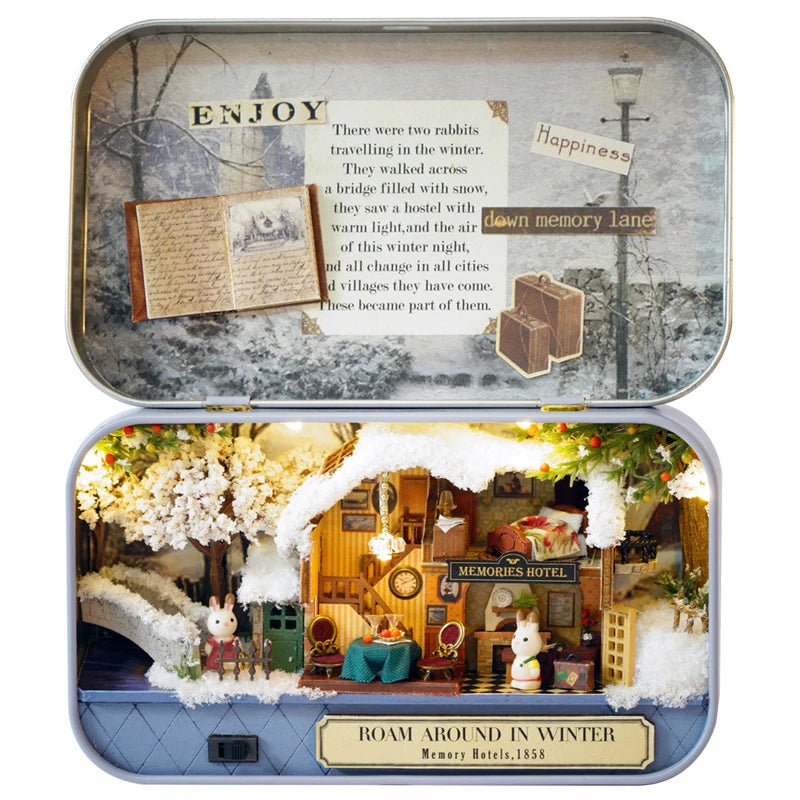 A vintage wooden miniature dollhouse theater kit featuring a detailed interior scene with furniture and snowy elements.