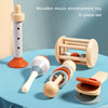 A 5-piece set of wooden music and alinstrument toys including a large pipe, various wooden bells, and other sensory play item