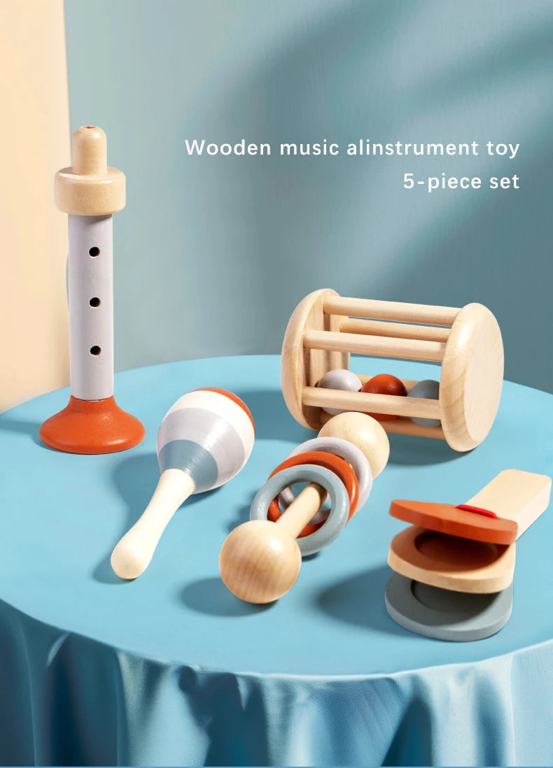 A 5-piece set of wooden music and alinstrument toys including a large pipe, various wooden bells, and other sensory play item