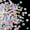 A collection of small, gradient colored acrylic bellflower beads in various shades of pink, blue, and yellow.