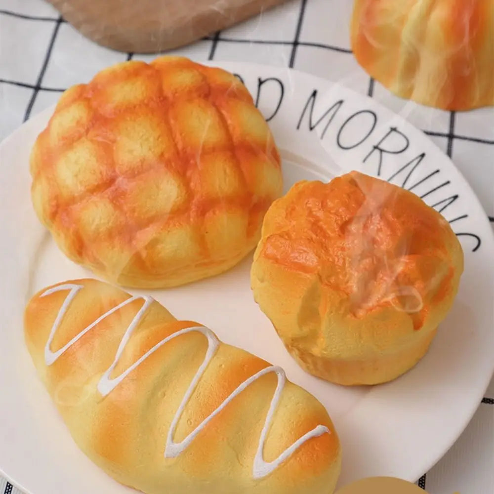 A plate featuring baked goods including a round loaf and a braided loaf, likely bread or pastry.